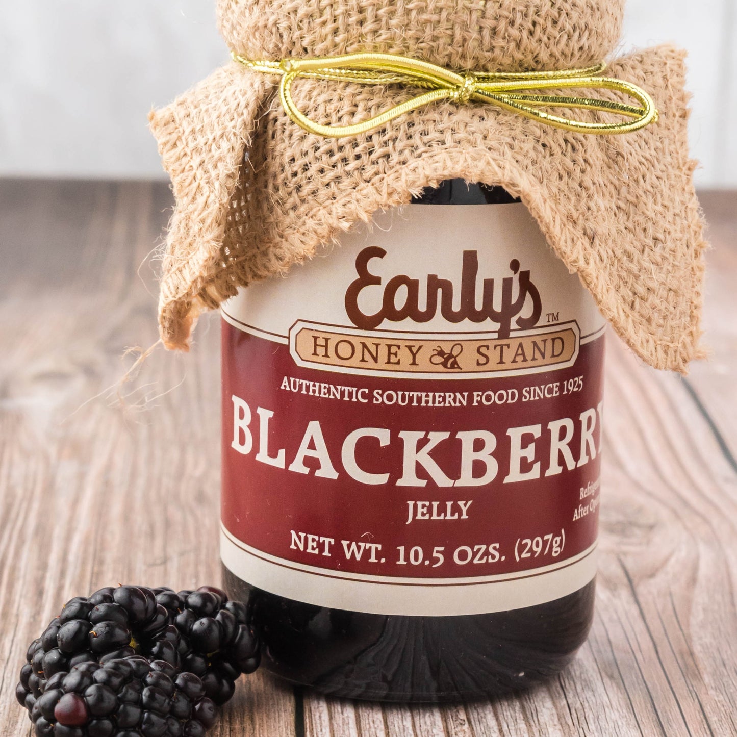 Early's Honey Stand Blackberry Jelly with burlap topper, Blackberrys nestled next to the 10.5 oz jar. Perfect southern nostalgia biscuit topper