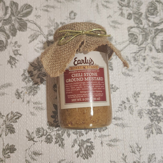 Jar of chili Stone Ground Mustard on floral background