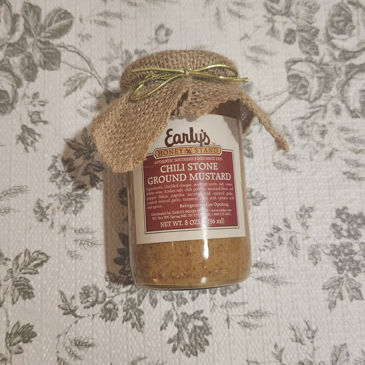 Jar of chili Stone Ground Mustard on floral background