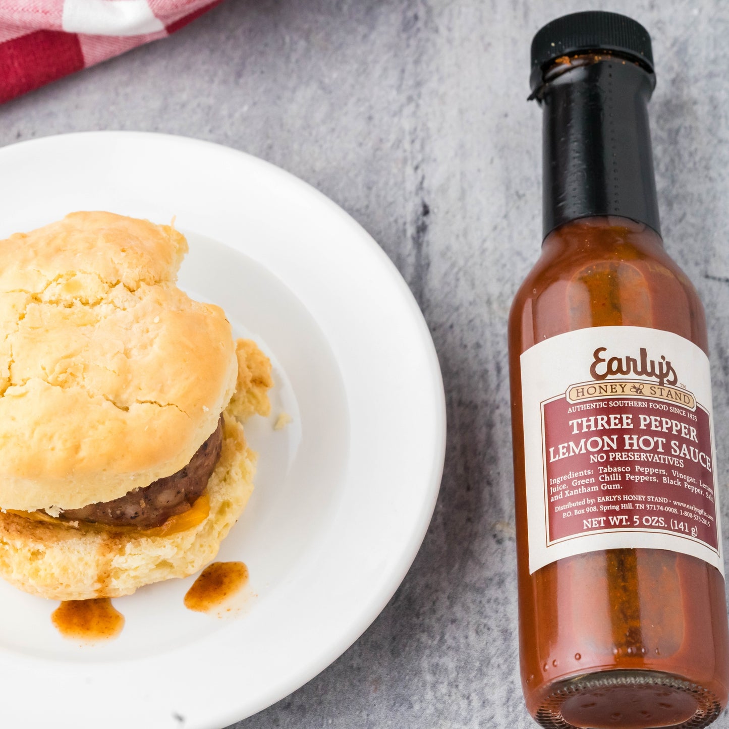 Three Pepper ( Toabasco, Chilli and Black pepper) Lemon Hot sauce- Pictured with a sausage biscuit