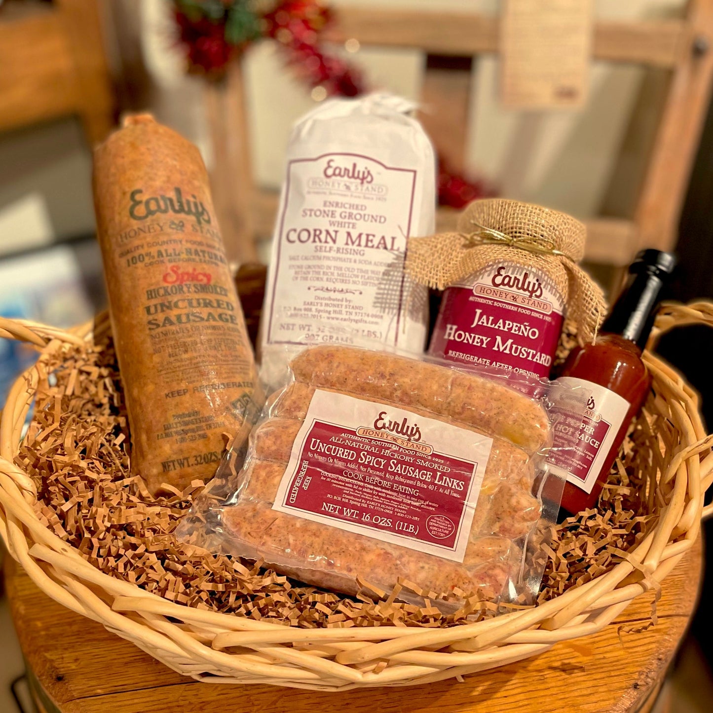 Early's Honey Stand's 'Hotter than a Firecracker' gift box, featuring spicy sausage, mustard, hot sauce, and cornmeal. The items are beautifully arranged in a shippable gift box, perfect for anyone who loves bold, spicy flavors.